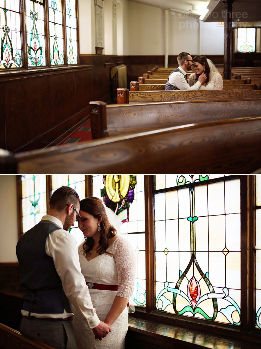 050 Newly married couple inside First Baptist Church with beautiful stained glass windows