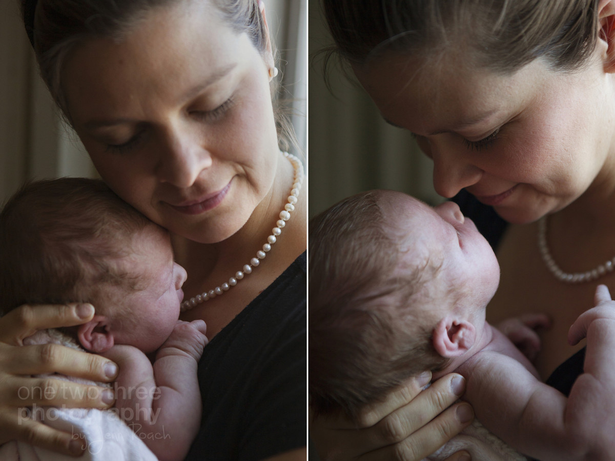 Mother holding her newborn daughter during a natural newborn baby photography session with a photojournalistic style