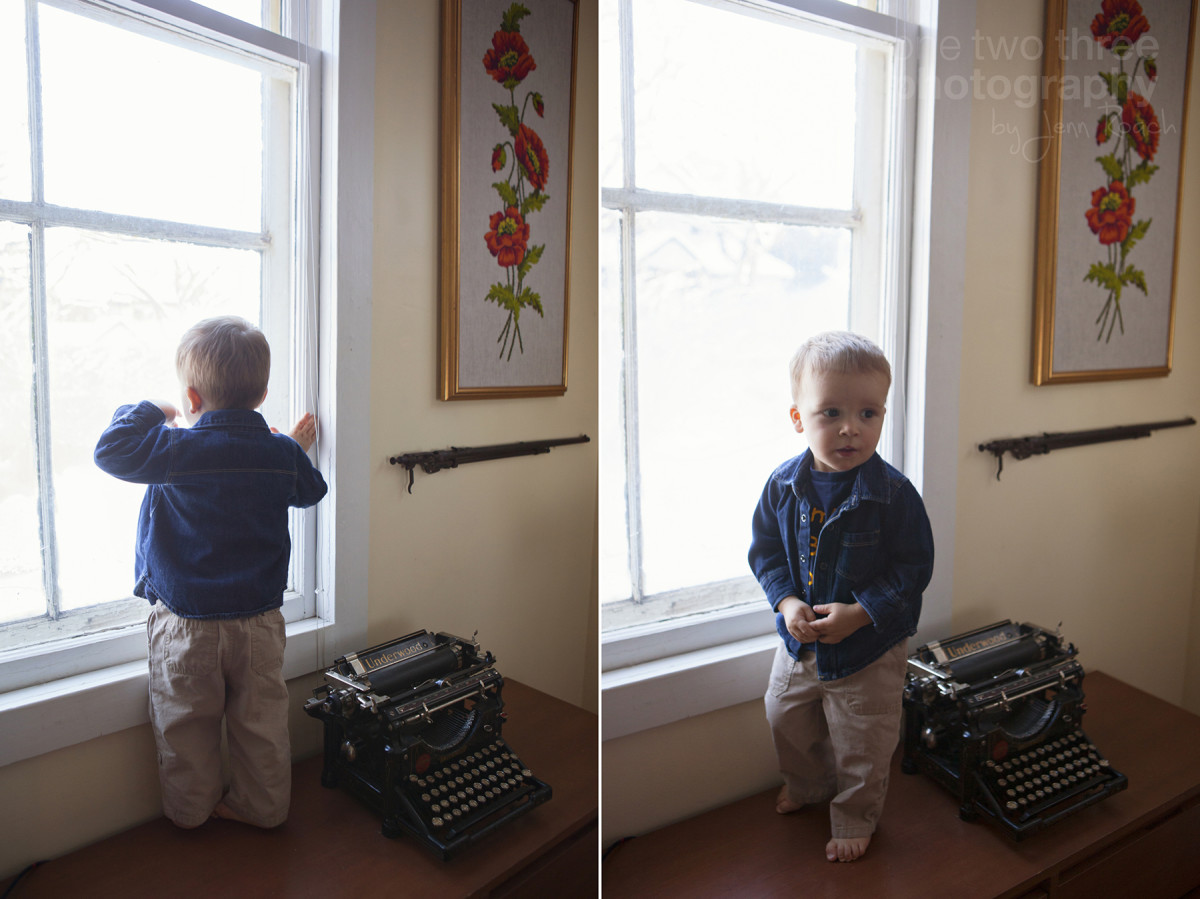 Elias stands by the window in his home next to an antique Underwood typewriter