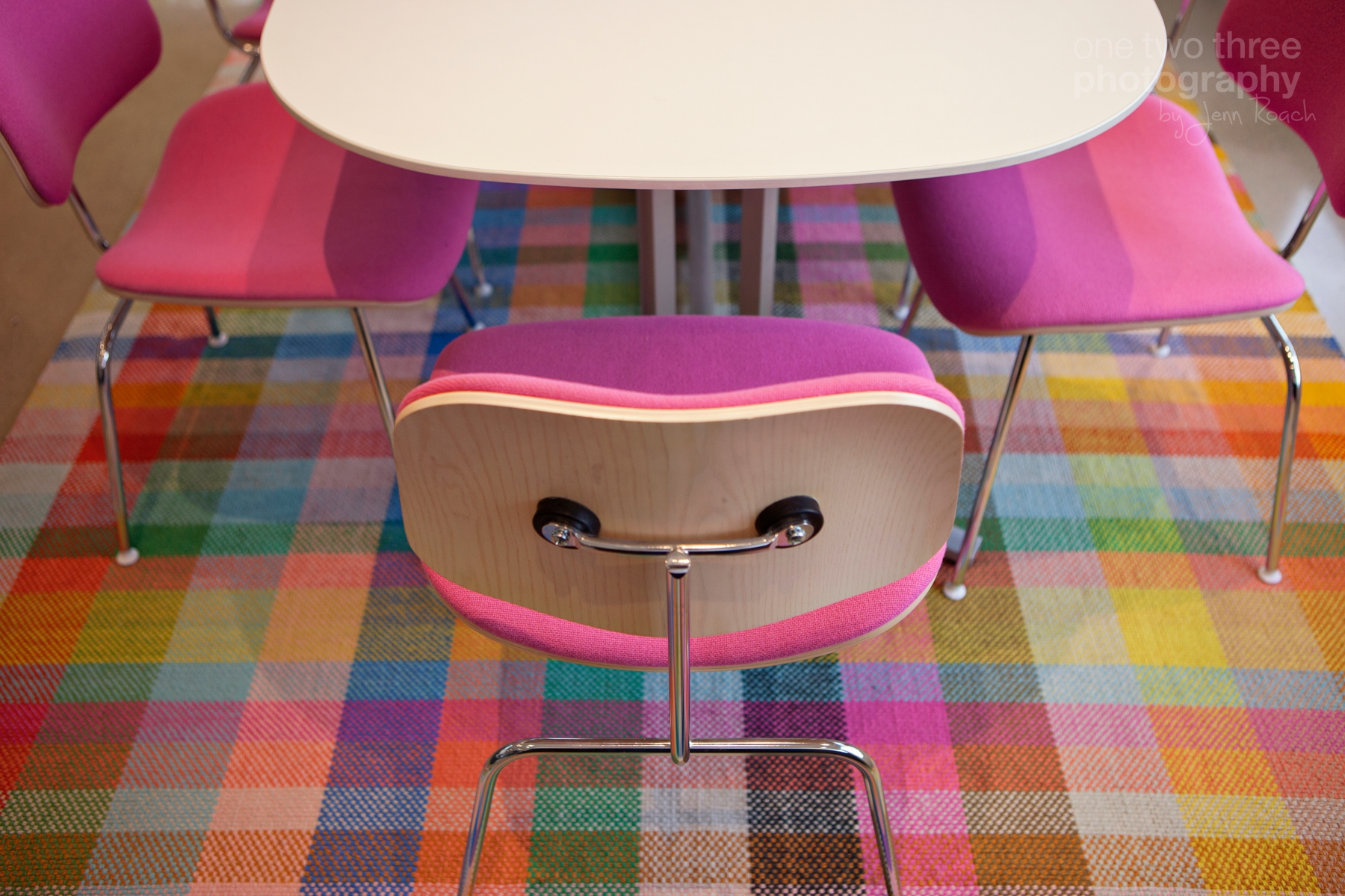 Pink chairs at a dining room table or office meeting table