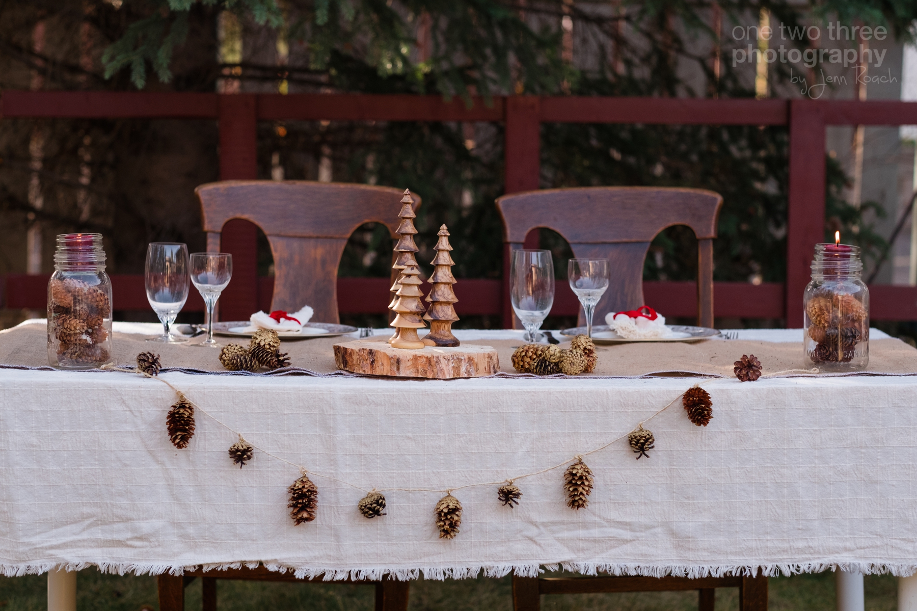 Rustic wedding table settings with pinecones and wood